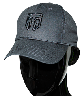 Black cotton baseball cap with a black GTG embroidered logo on a black dummy head, seen from front left angle. The cap’s visor is curved and has a series of parallel black stitches from the edge to the base of the cap. Stitches also join the squatchee from the bottom of the cap.