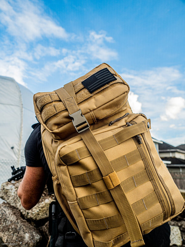 Front of cobra tactical sling backpack in desert sand colour on male model.