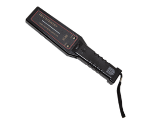 Picture of the flat control surface of a black, hand-held security metal detector, crossing diagonally form the top left to the bottom right corner, a black wrist strap hanging vertically to the right of the shaft edge. The upper half coil surface is wider than the lower half and its LED signal indicator bar and two LED spotlights, signals for readiness and alert, are framed by a red contour line. The shaft has a manual emission button at the edge of the control surface, followed by the alert sound trigger.