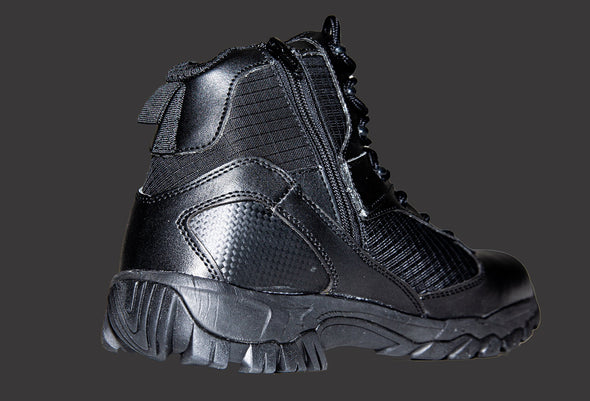 Picture from an inside-back angle of a left, ankle height, fully black boot. The boot displays the inch-high outsole, topped by the intricate combination of leather and mesh fabric of the boot, with pull tab at the top, and the lateral zipper.